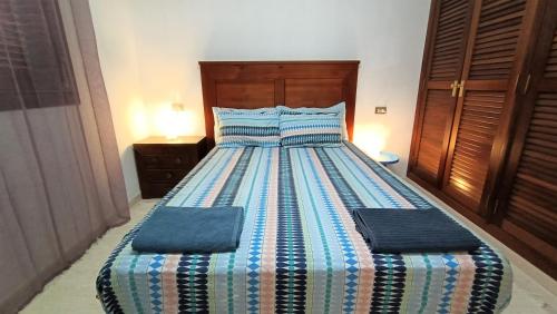 厄尔梅达诺alquilaencanarias Tio Claudio Beach的卧室内的一张带两个枕头的床