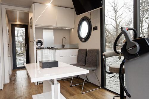 奥瓦瓦Apartament na wodzie - Riveraparts - Marina Oława的小厨房配有白色桌子和窗户