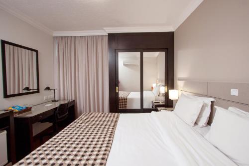麻布库里提巴商务酒店客房内的一张或多张床位