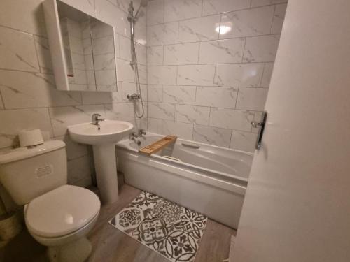 普雷斯顿Cheerful 4 bedroom close to Uclan, Preston City Center的白色的浴室设有水槽、卫生间和浴缸。