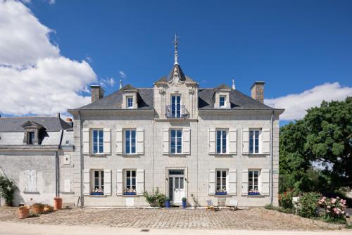 Saint-MathurinCasa Mila & SPA- Chambres d'Hôtes raffinées vue Loire et piscine的一座白色的大房子,上面有塔