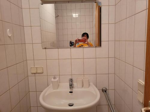 德累斯顿Mickten Hertz的一位妇女拍着浴室水槽的照片