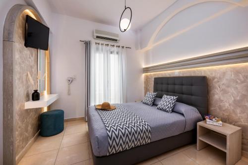 费拉Petros Villa的一间卧室配有一张床和一台平面电视