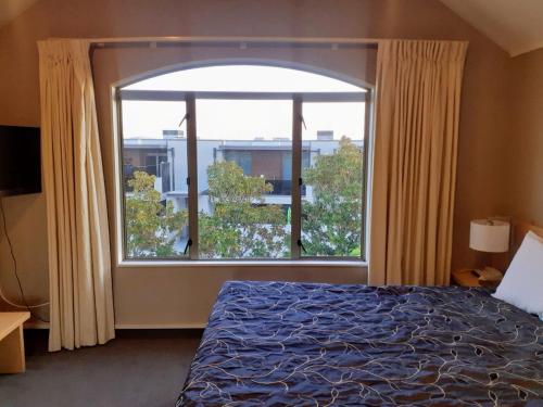 陶波Apartment Fourteen的一间卧室设有一张床和一个大窗户