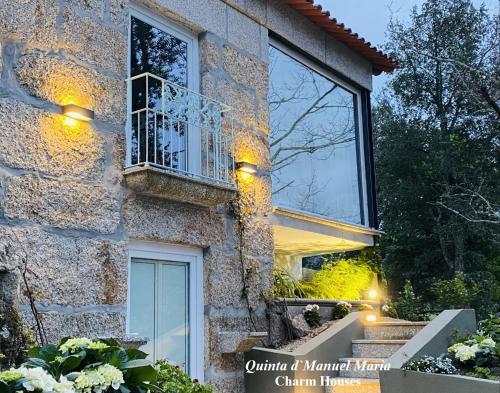 阿马兰特Quinta D`Manuel Maria- Rural Charm Houses的石头房子设有窗户和阳台
