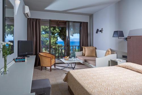 Gastouri奥罗斯海滩度假酒店的酒店客房设有床和客厅。