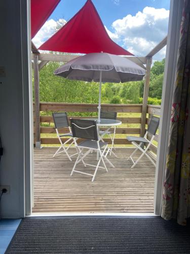 Ferdruptdomaine des planesses的庭院配有桌椅和遮阳伞。