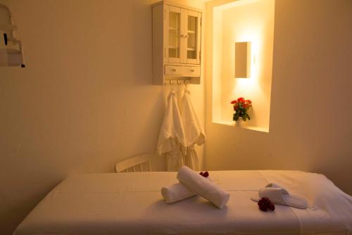 彼得罗波利斯日光因佩里奥酒店的一间卧室配有一张床,上面有两条毛巾