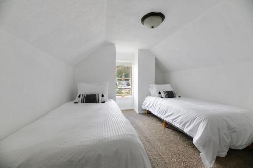 利德The Overlook Nook的白色的客房设有两张床和窗户。