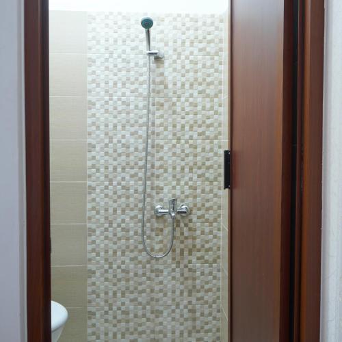 JetisDjuragan Kamar Ayem的浴室里设有玻璃门淋浴