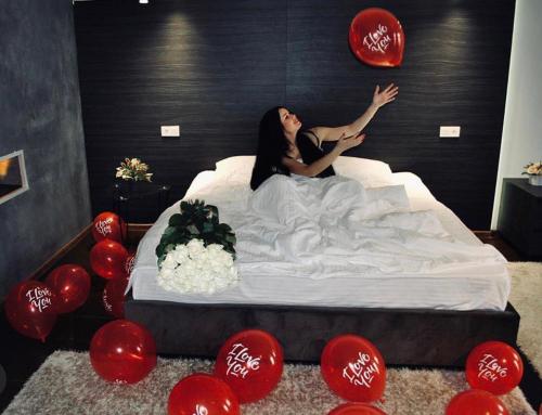 敖德萨Club House Arkadia Beach的躺在红色气球室床上的女人