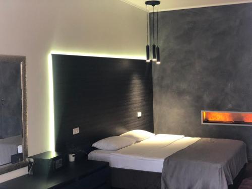 敖德萨Club House Arkadia Beach的一间卧室配有一张带黑色床头板的床