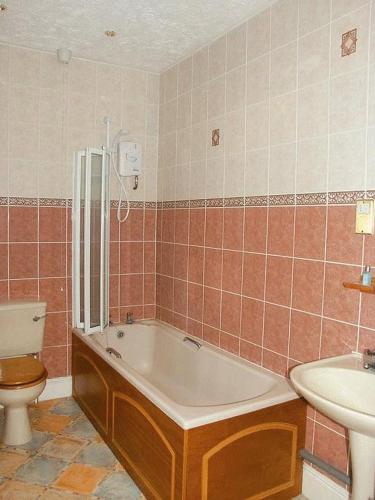 金斯林葛兰奇酒店的带浴缸、卫生间和盥洗盆的浴室