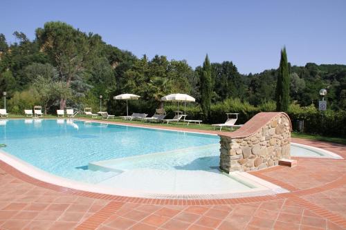 雷杰洛瑞伽奇别墅酒店的一个带椅子和遮阳伞的大型游泳池