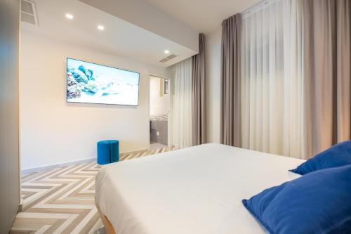 马里纳-迪-皮特拉桑塔Garden Suite的卧室配有一张床,墙上配有电视。