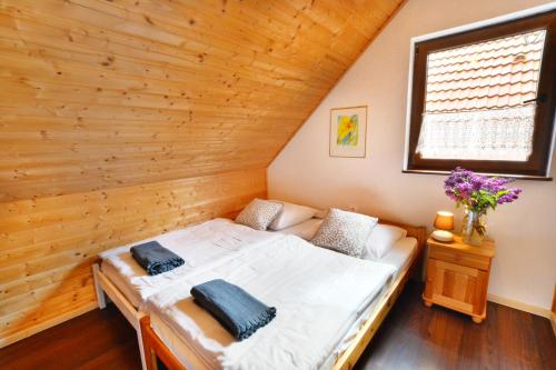 波波林Domki Gościniec Bobolin的木墙客房的一张床位