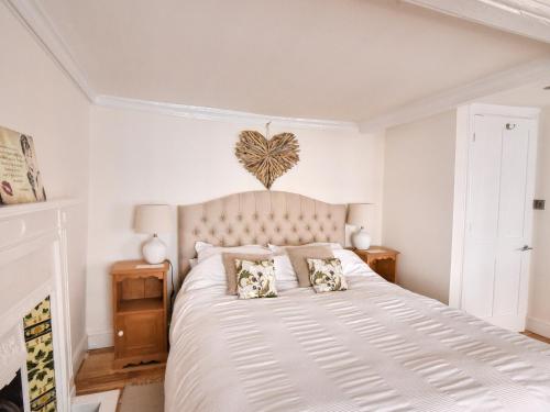 莱姆里吉斯The Little Rose的卧室配有一张带两个枕头的大白色床