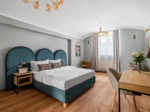 布拉格numa I Libusa Apartments的一间卧室配有一张大床和蓝色床头板