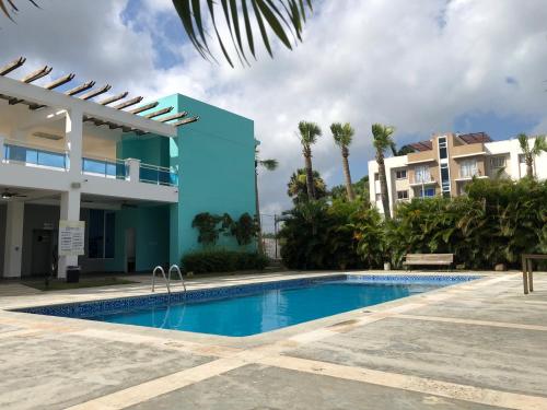 圣地亚哥洛斯卡巴Oasis Palma Real santiago, Republica Dominicana的大楼前的游泳池