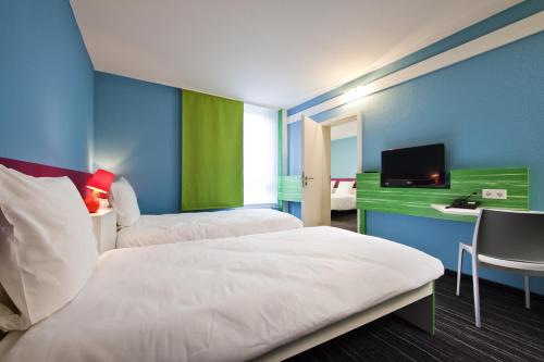 诺伊斯杜塞尔多夫诺伊斯宜必思尚品酒店的酒店客房设有两张床和电视。