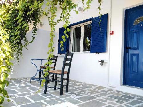 迈洛波塔斯Nissos Ios的一个带两把椅子和蓝色门的庭院