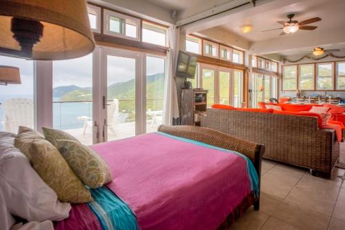 淡水池塘Tortola Adventure Private Villa Ocean-View Pool的一间卧室配有一张床,享有海景