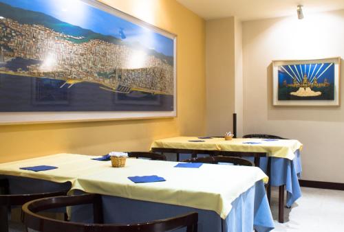 巴塞罗那Atlantis by Atbcn的一间用餐室,配有两张带蓝色餐巾的桌子