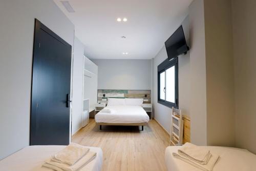 塞丹约拉·德尔·瓦勒Hey Rooms的一间卧室配有两张床和一台平面电视
