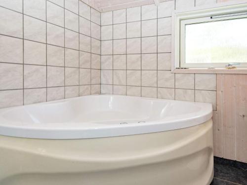 海默特8 person holiday home in Hemmet的带窗户的浴室内的白色浴缸