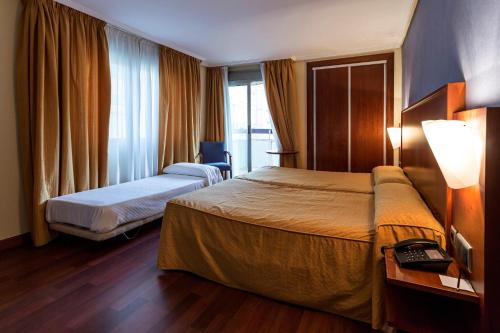托雷鲁兹中心酒店客房内的一张或多张床位