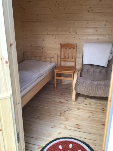 科林基拉Koli caravan cottages的小房间设有一张床和一把椅子
