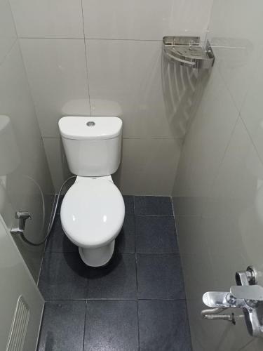 班图尔Srikandi Baru Inn Blok O的浴室位于隔间内,设有白色卫生间。