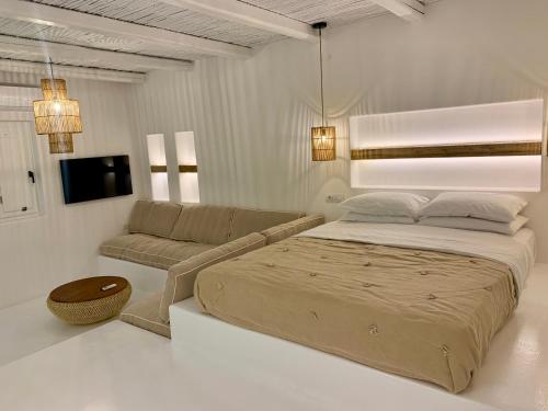 伊奥斯乔拉伊奥斯伊亚罗斯酒店的一间卧室配有一张大床和一张沙发