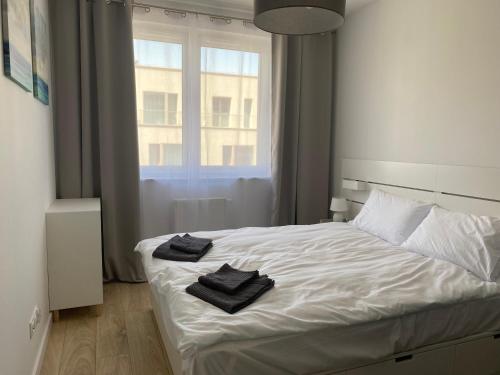 弗罗茨瓦夫Gdańska Duo的卧室配有白色的床和2条毛巾