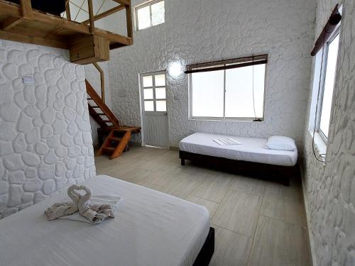 科韦尼亚斯Hotel Cabaña Playa DanRay的一间卧室设有两张床,床上配有泰迪熊
