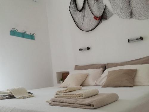 马蒂诺Dimora Ermete的一张白色的床,上面有两个枕头