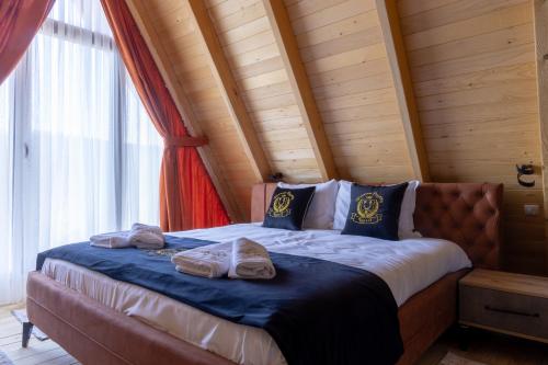 OrllanBatllava Premium Resort Villa 1的一间卧室配有一张带两个枕头的床