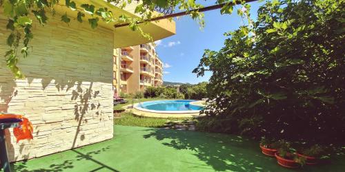 金沙Riviera Sea VillageApartments Golden sands的后院设有游泳池和大楼