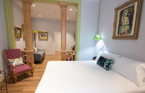 安度亚尔Hotel Oleum - Parking Gratuito Reserva Previa的卧室配有一张白色大床和一把椅子