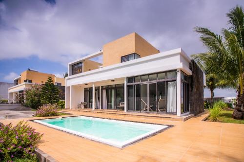 贝尔马尔Villa Fitz: Sunlit Beach Getaway w/ Pool + WIFI的一座房子前面设有游泳池