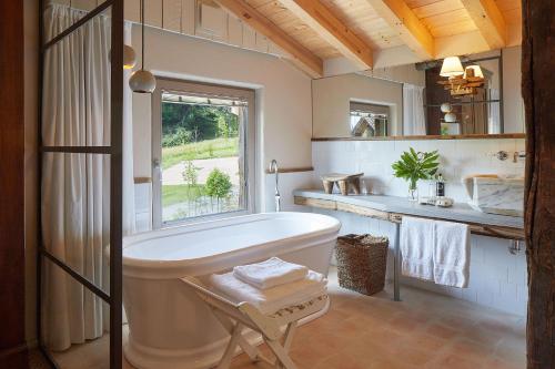 杜兰戈OAR Cottage的带浴缸、窗户和水槽的浴室