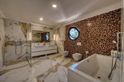 维利伊兹Villas Anita的带浴缸、淋浴和盥洗盆的浴室
