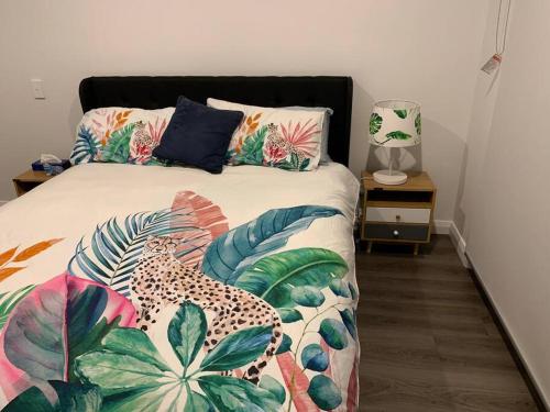 新城North Hobart, Tranquil Retreat, No Stairs, Access的一间卧室配有一张带豹子和热带枕头的床。