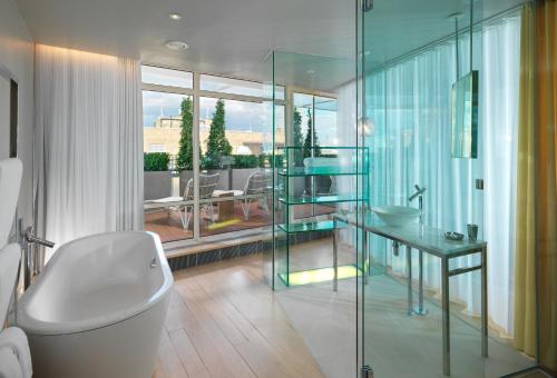伦敦Sanderson London的带浴缸和玻璃淋浴间的浴室。