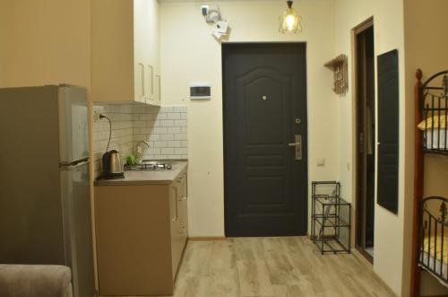 高尼奥Gonio - Stumari Apartaments的厨房位于柜台旁,设有黑色的门