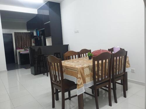 斯里曼绒HOMESTAY IMPIAN QASEH MANJUNG (MUSLIM)的一间带桌椅的用餐室