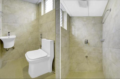 班加罗尔Fly Inn的浴室配有卫生间、盥洗盆和淋浴。