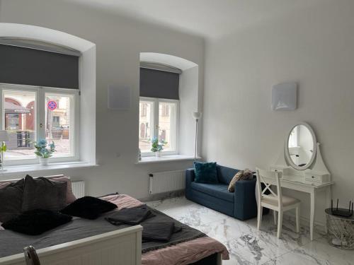 里加Riga Center Apartment in Old Town的一间卧室配有一张床、镜子和椅子