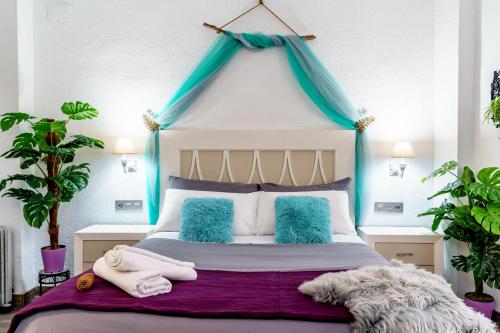 格拉纳达My Granada Garden - Mimosa studio的一间卧室配有一张蓝色天蓬床