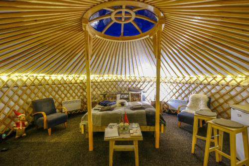 罗瓦涅米Yurt District的蒙古包内一间卧室,配有一张床和椅子